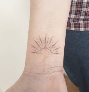 Dot Work Sunburst Tattoo on Wrist