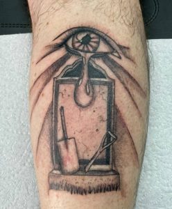 10 Beautiful Gray Ink Leg Tattoo Art With Falling Tear from Eye on Digging Headstone by Broken Grubber