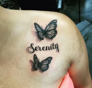 11 Lucrative Black Inked Butterflies with Writing Serinity Tattoo for Pretty Girls on Chest