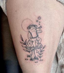 12 Mind Blowing Small Frog Chilling a Geat Time Sitting on Mushroom Garden Tattoo on Thigh