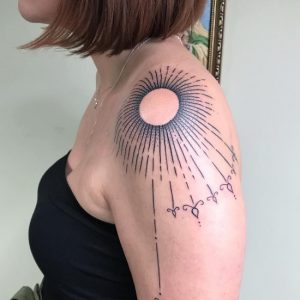 amazing linework Sunburst Tattoo on shoulder