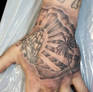 Sunburst Tattoo with palm tree & Ship on hand