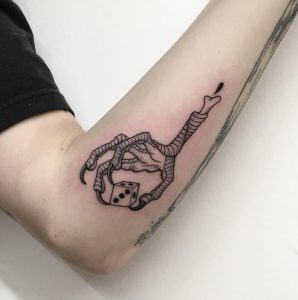 16 Stunning Black Art Devil Claw is Holding Dice Tattoo on Elbow