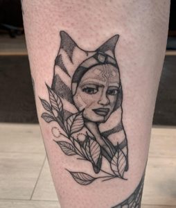 19 Black Color Inked Ahsoka face with Leaves Tattoo on Lower Leg