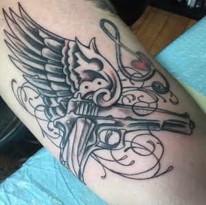 19 Fantastic Black Inked 1911 Pisto Tattoo with Bird Wings on Hand