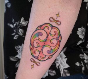 19 Swirly Pattern Brain with Infinity Symbol Rainbow Color Tattoo on arm