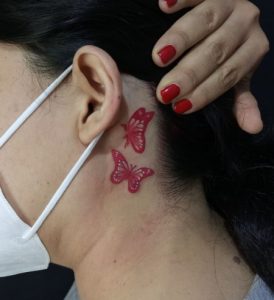 20 Little Red Butterflies Tattoo on Upper Neck and Behind the Ear