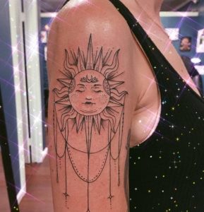 Sunburst Tattoo with dripping Jewels design on arm