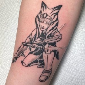 21 Black Color Inked Small Ahsoka Tattoo with Her Sword on Sleeve