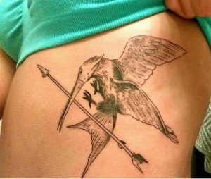 21 Stunning Lovely Mockingjay Flying Birds with Arrow Tattoo on Rib