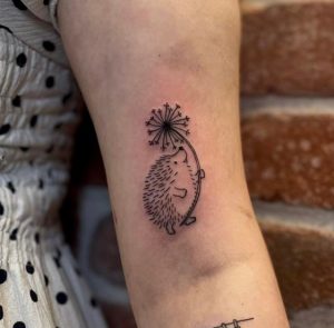 Small Hedgehog Holding Flower Tattoo