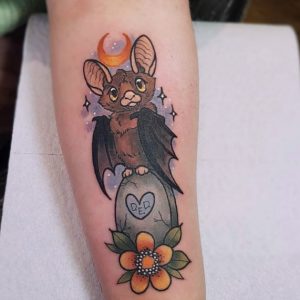 23 Pricious Designed Bat Sitting on the Tombstone in Greavyer at Orange Moon Night Tattoo on Hand