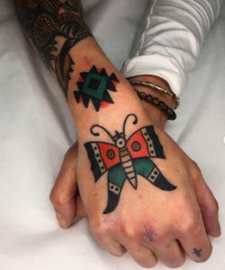 25 Legendary Solid Multicolor Inked Butterfly Tattoo on Upper Next to Fingers