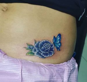 26 Tiny Blue Color Rose Butterfly Tattoo on Lower Belly Part