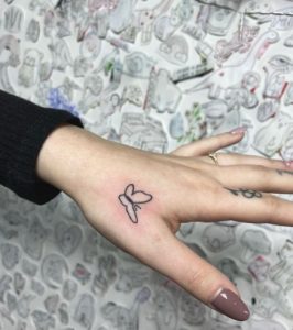 27 Mini Simple Butterfly Tattoo for Female Next to Upper Thumb Finger