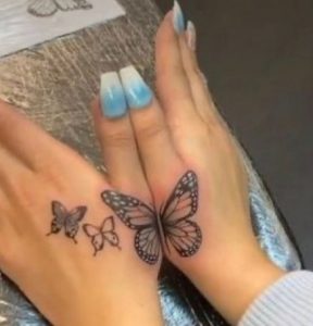 29 Black Color Inked 3 Butterflies Tattoo for Pretty Girls Next to Upper Thumb Finger