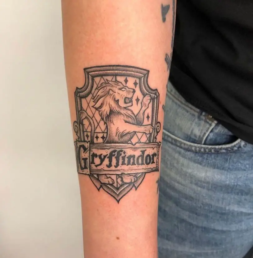 31 Praisworthy Black Ink Work Small Lion Gryffindor Tattoo on Forearm