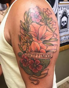 34 Floral Design Gryffindor Written Tattoo on Half Sleeve