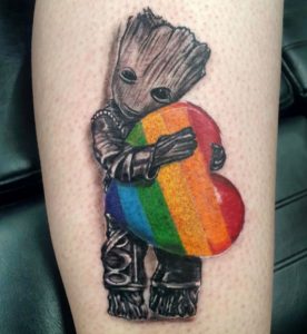 6 Tree Man Holding Rainbow Color Lovely Heart Tattoo on Lower leg