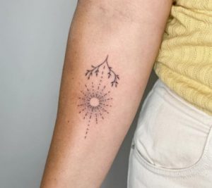 dot work Sunburst Tattoo with tree design on Forearm