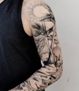 Sunburst Tattoo with palm tree design arm