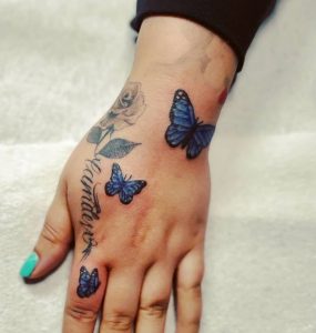 8 Outstanding Blue Black Inked Butterflies with Name Tattoo for Pretty Lady on Next to Finger