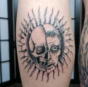 Sunburst Tattoo with Skull design on Leg