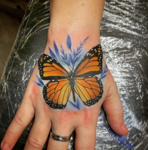 9 Amazing Realistic Color Inked Butterfly Tattoo for Female on Finger Upper Side