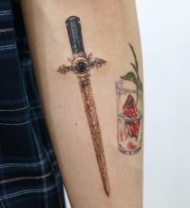 9 Golder Color Gryffindor Dagger Tattoo on Half Sleeve