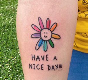 93 Cute Rainbow Sun with Grettings Tattoo on Arm