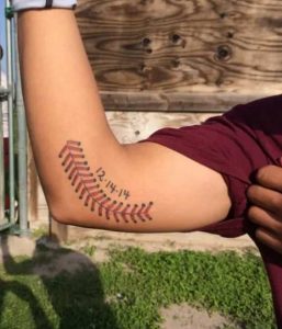 Baseball stitch tattoo on elbow 2