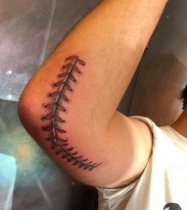 Baseball stitch tattoo on elbow 3