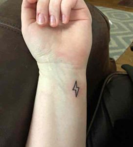 Tiny lightning bolt tattoo on the wrist