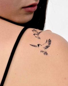 Sparrow tattoos flying through