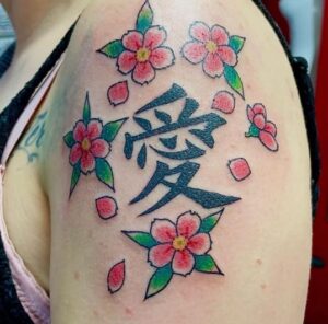 Red Flowered Black Arm Tattoo