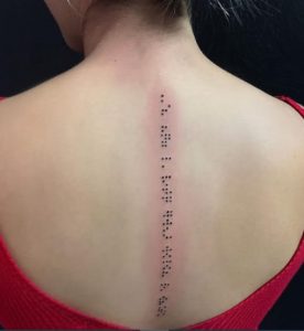 Braille spine tattoo