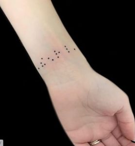 Braille arm tattoo