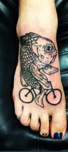 Fish riding bicycle on the toe