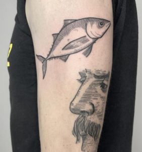 The man faced black Tuna tattoo
