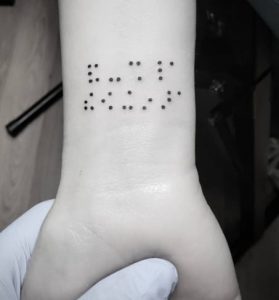 Braille arm tattoo black and white