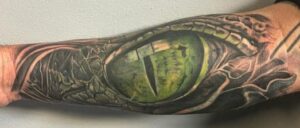 Alligator eye tattoo