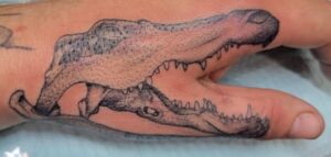 Alligator finger tattoo