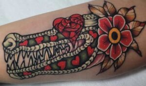 Floral alligator head tattoo