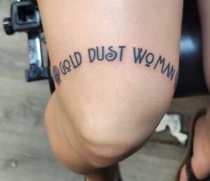 Above Knee Lettering Tattoo
