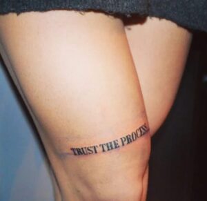 Above Knee Quote Tattoo