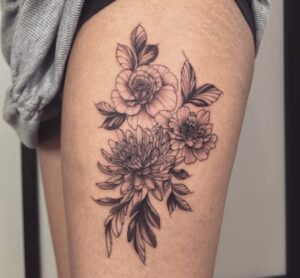 Black-Inked Floral Thigh Tattoo