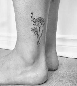 Black inked Marigold Lower Leg Tattoo