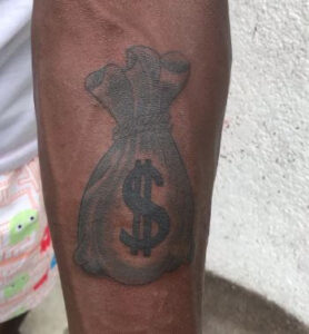 arm money bag tattoo