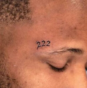 222 angel number tattoo on face
