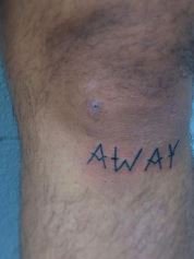 knee cap letter tattoo